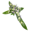 A solemn, elegant floral cross shown from a slight overhead angle against a clean white background, the composition balanced and quietly reverent. The cross's structure is formed from broad, glossy tropical leaves - think Ti or similar waxy greens - their deep emerald surfaces and prominent veins layered to mark the arms and central shaft with a lush, durable foundation. At the heart and stretching along each arm sits a generous, thoughtfully layered cluster of pale blooms: soft, ruffled lisianthus in creamy ivory and pure white, their multiple petals and unopened buds giving a sense of gentle unfolding; small, rounded white chrysanthemum florets that add brightness and a fine textured edge; and sprays of tiny lavender to light-purple starry accents - likely limonium or small asters - which thread through the white flowers to give depth and a whisper of colour. Fine green filler foliage is woven lightly between the blooms, softening transitions and enhancing a feeling of natural abundance. Light falls evenly across the arrangement, picking out the waxy sheen of the leaves and the delicate translucence of the lisianthus petals, while a barely-there green, fresh scent can be imagined-subtle, clean, consoling. This piece reads as a traditional sympathy tribute, appropriate for funeral services, a graveside ceremony, or a church remembrance, communicating peace, faith and a quiet hope of eternal rest. As a local florist in Emerson Park I often place such crosses for families gathering at nearby churches or memorial services by Harrow Lodge Park and the Hornchurch community; its restrained palette and classical form make it a dignified expression of condolence and enduring affection.